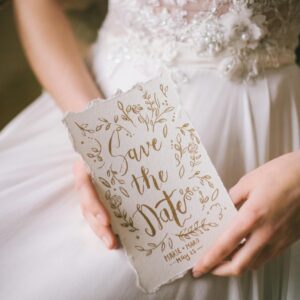 Woman in White Dress Holding a Wedding Invitation